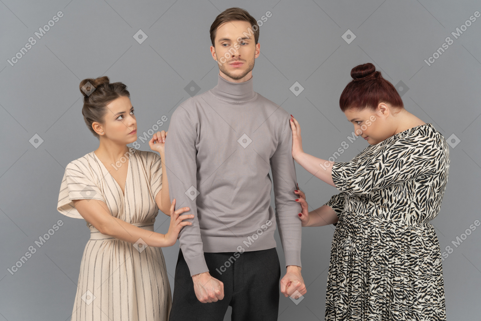 Young man showing his anger to two frightened women