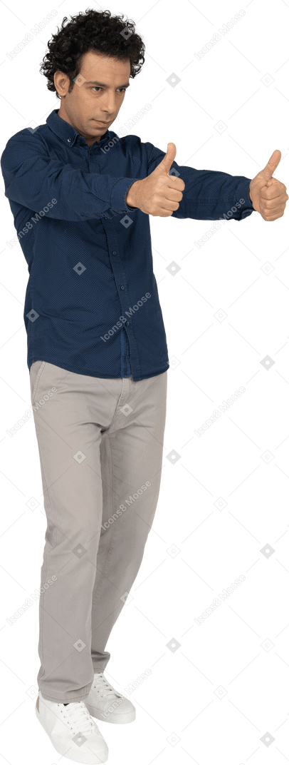 Front view of a man in casual clothes showing thumbs up