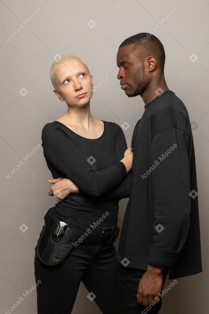 Young woman standing with a man and looking up