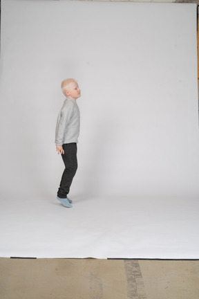 Side view of a jumping little boy