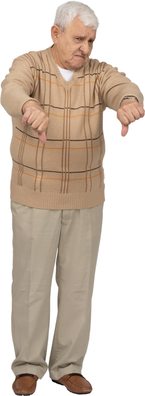 Front view of a sad old man in casual clothes showing thumbs down