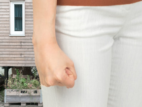 A close up of a person clenching their fist