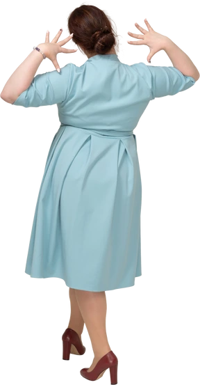 Rear view of a woman in blue dress posing