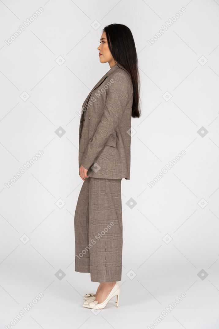 Side view of a young lady in brown business suit