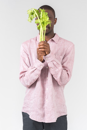 Good looking young man holding flowers