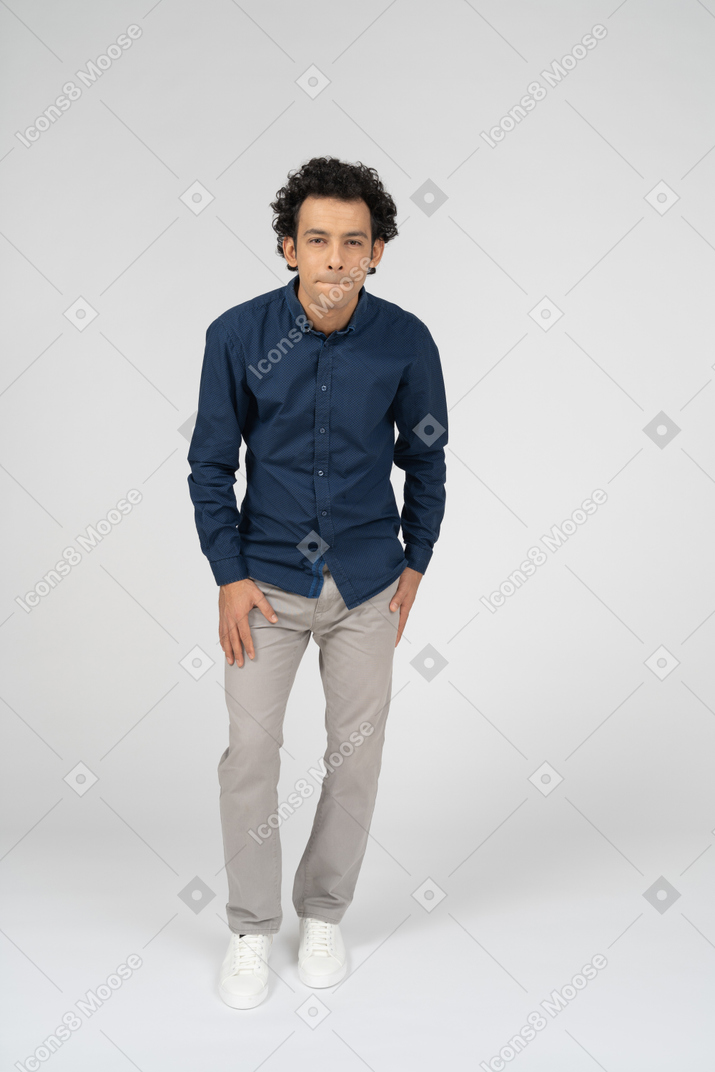 Front view of a man in casual clothes making faces