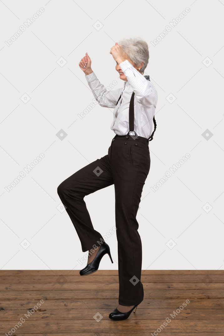 Side view of a businesswoman cheering