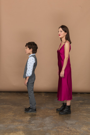 Young woman and little boy standing in profile