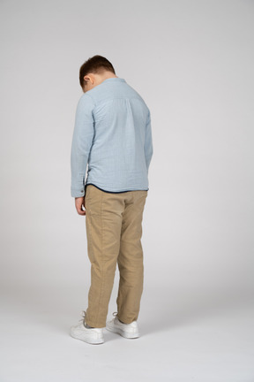 Back view of a boy bending head down