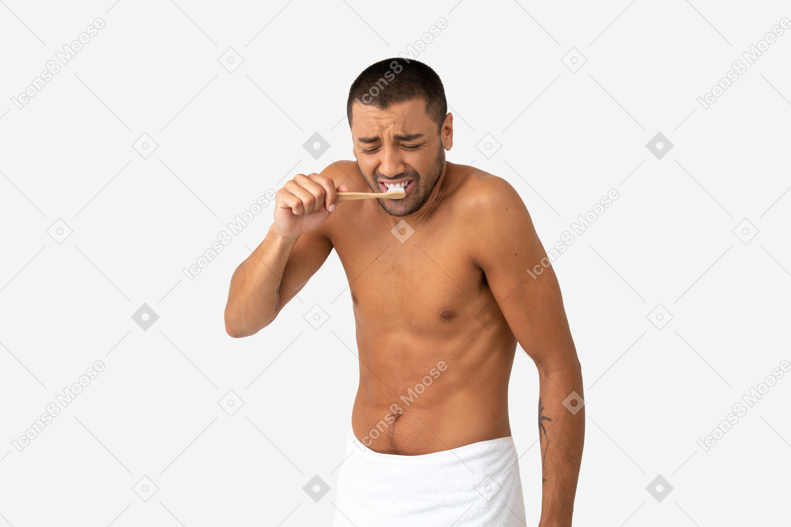 Barechested young man brushing his teeth with disgusted expression