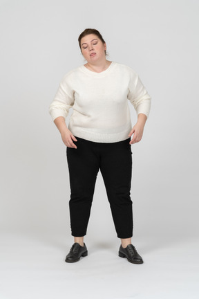 Front view of a plump woman in casual clothes making faces