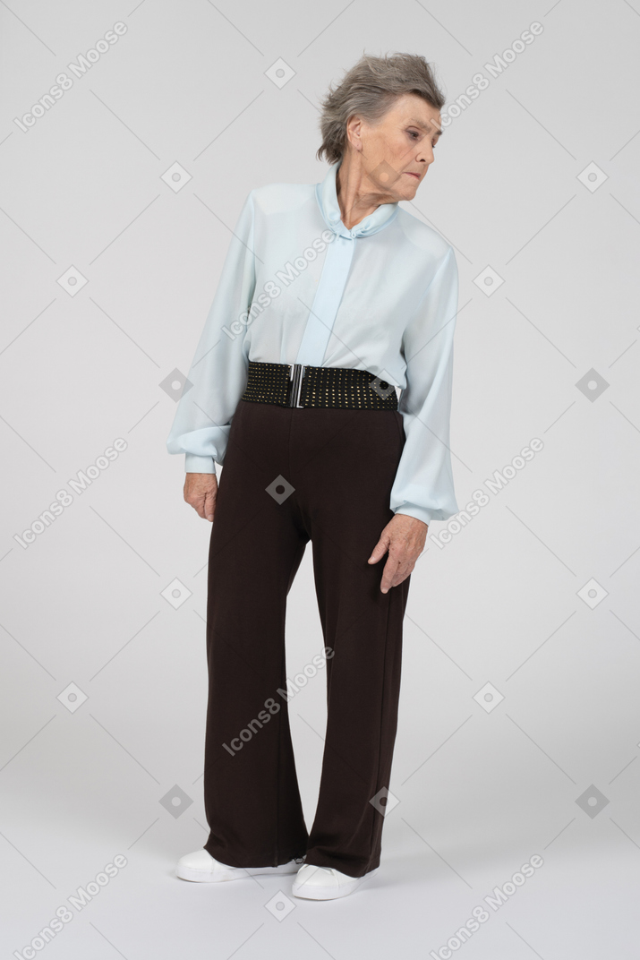 Old woman standing and turning away
