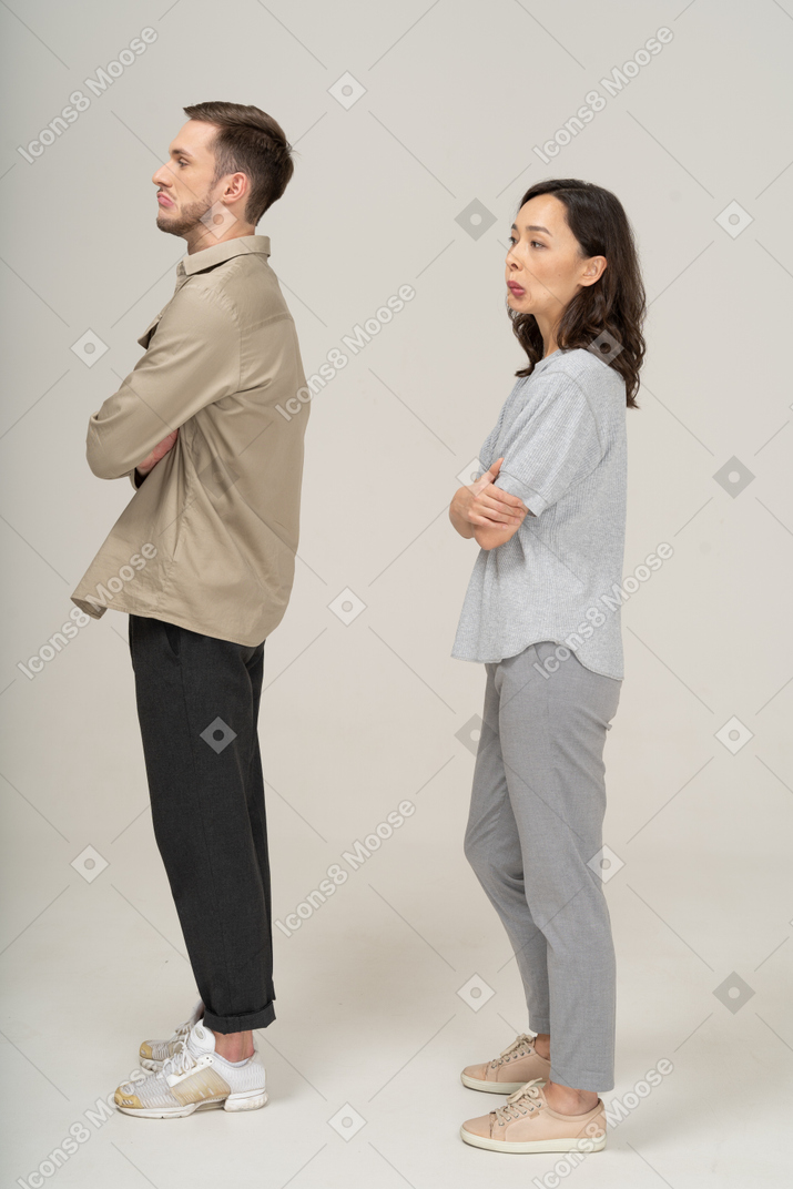 Side view of young couple pouting