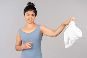 Young indian woman throwing towel away