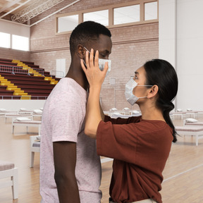 A man and a woman wearing face masks