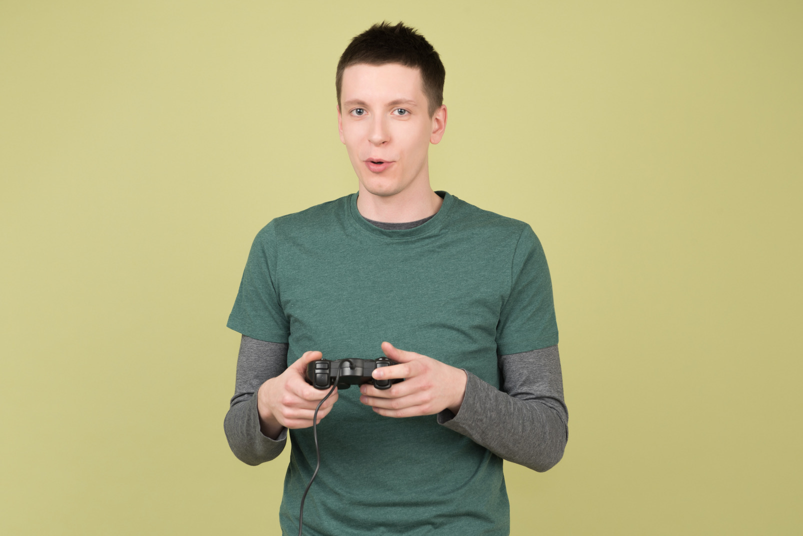 Young man holding game controller playing video games