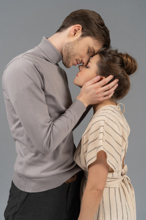 Young man caressing his girlfriend's face