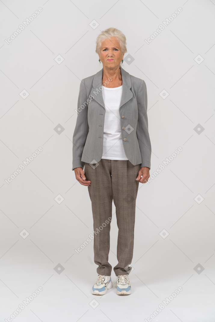 Front view of an old lady in suit looking at camera