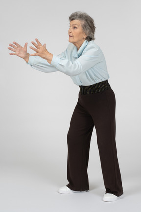 Old woman outstretching her hands