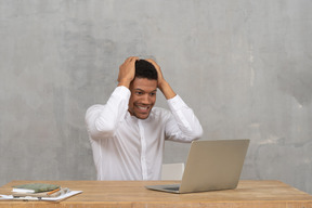 Young man touching his head