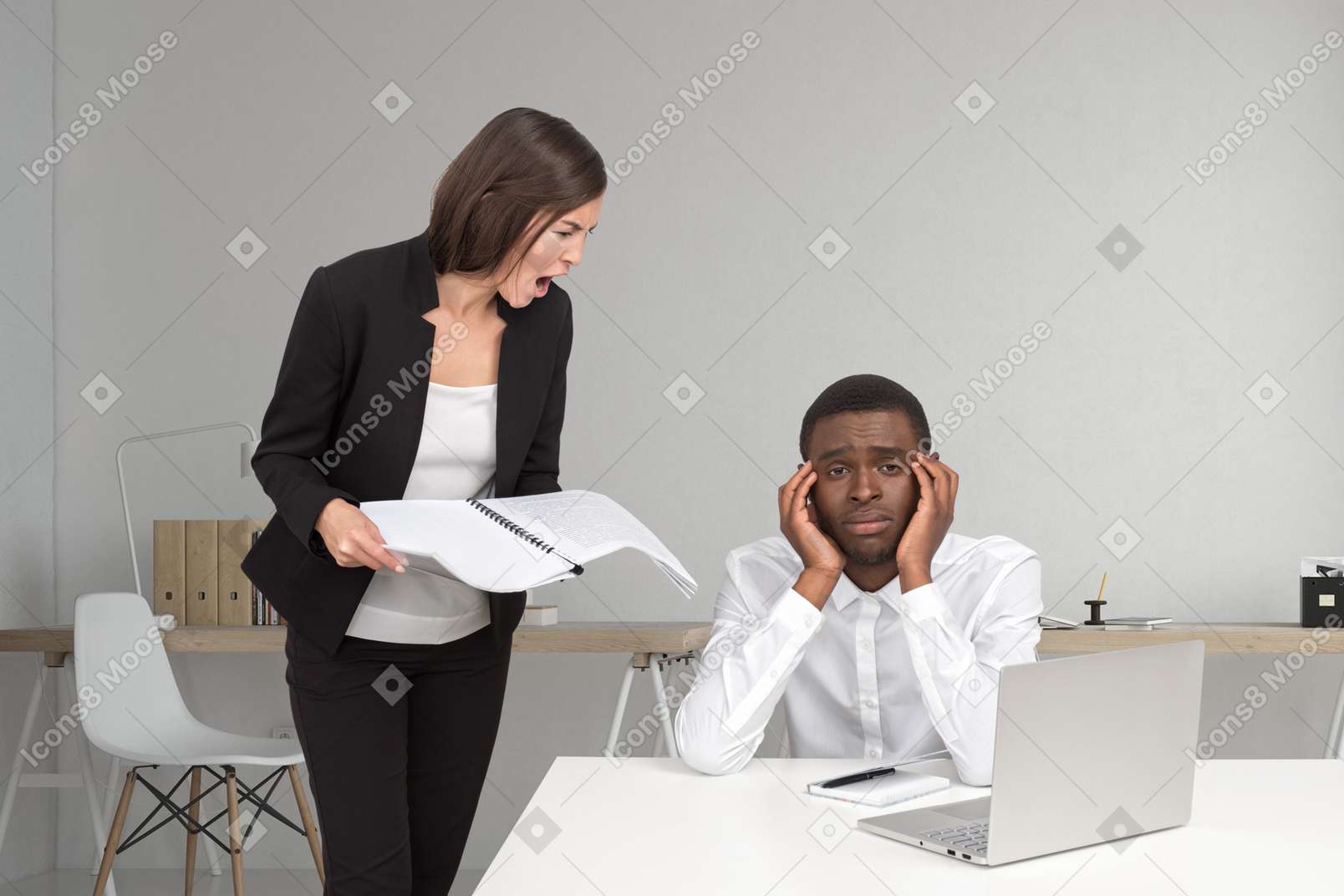 Female boss yelling at employee at laptop