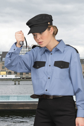 Confused policewoman in uniform looking at something