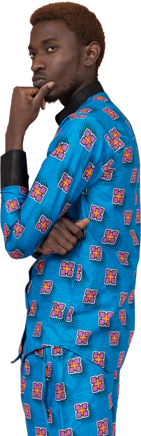 Black man in blue pajamas looking