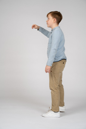 A young boy in a blue shirt and khaki pants