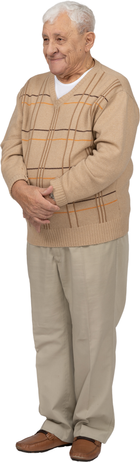 Front view of a happy old man in casual clothes standing still