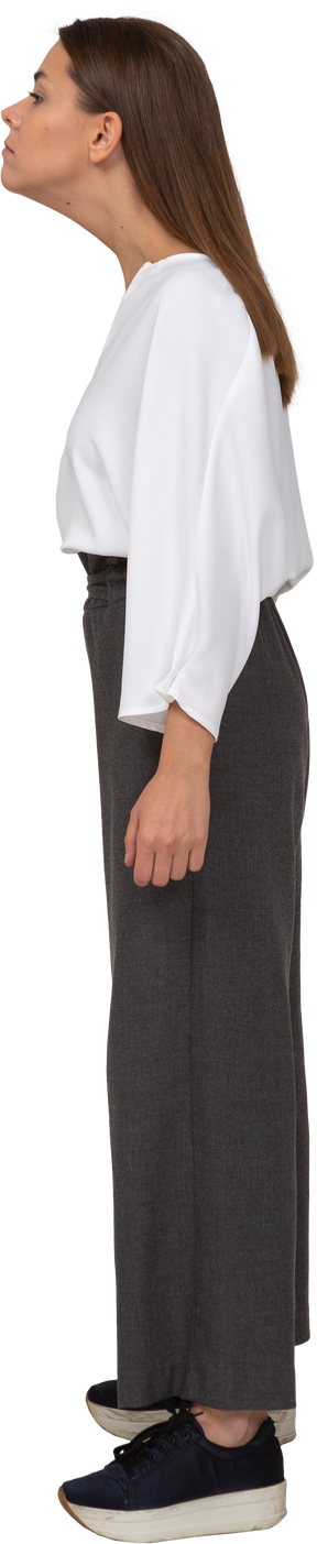 Side view of a young lady in office clothing outstretching her neck