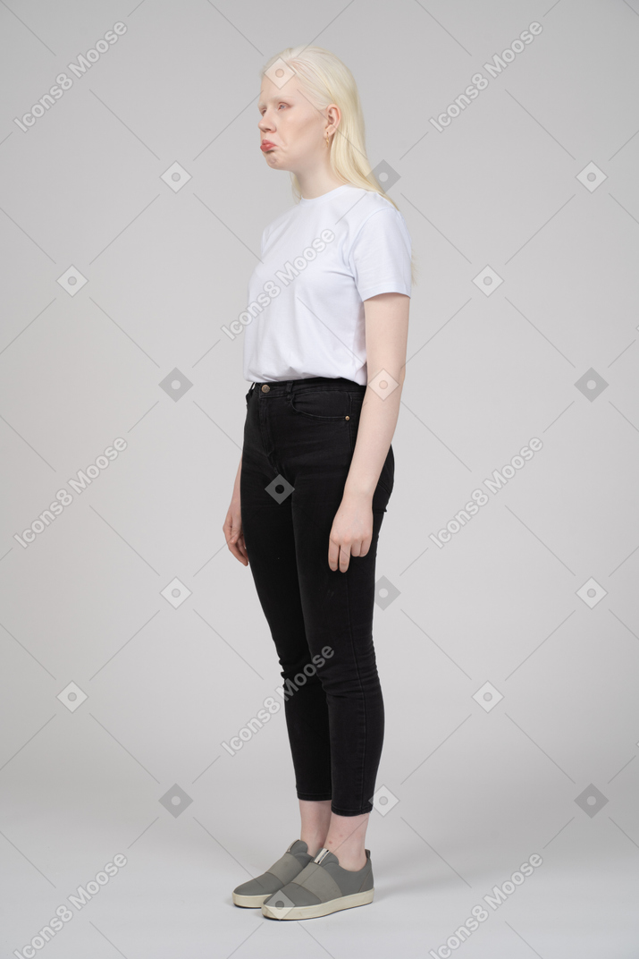 Unhappy young woman standing