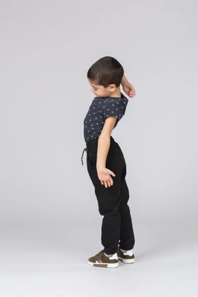 Side view of a cute boy stretching