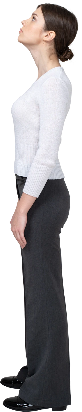 Side view of a young woman in office clothing looking down