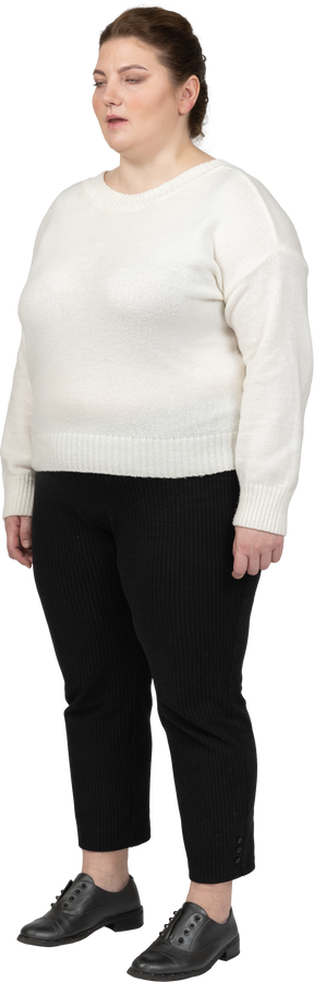 Plump woman in casual clothes standing with closed eyes