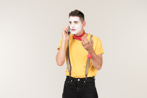 Male clown involved in phone talk