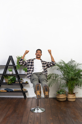 Good looking young man sitting on a chair