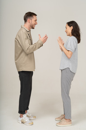 Side view of young couple speaking to each other