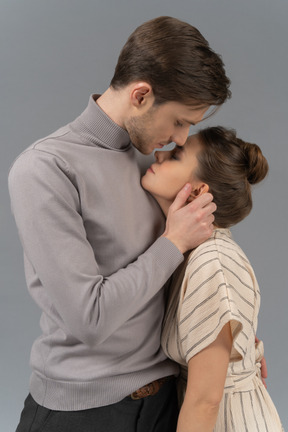 Young man caressing his girlfriend's face