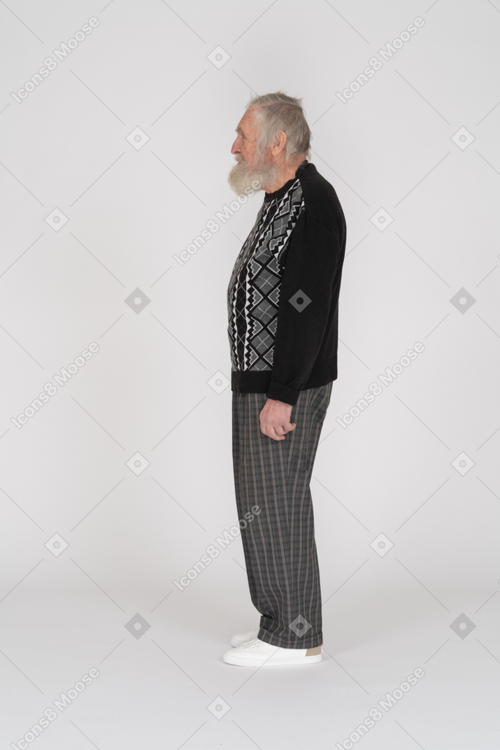Profile view of an elderly man standing