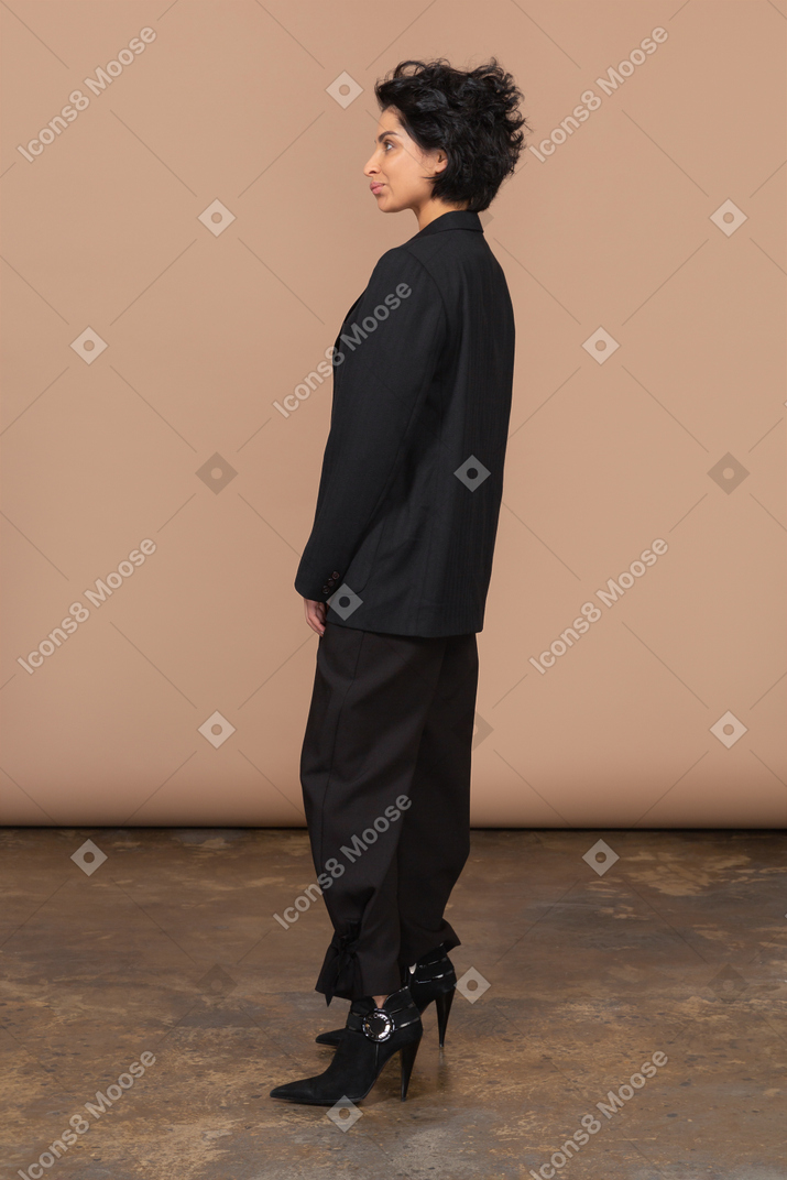 Side view of a grimacing businesswoman in a black suit