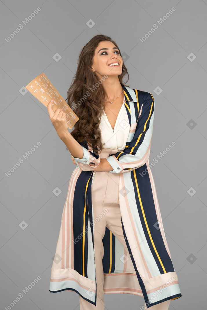 Smiling arab woman waving with a notebook
