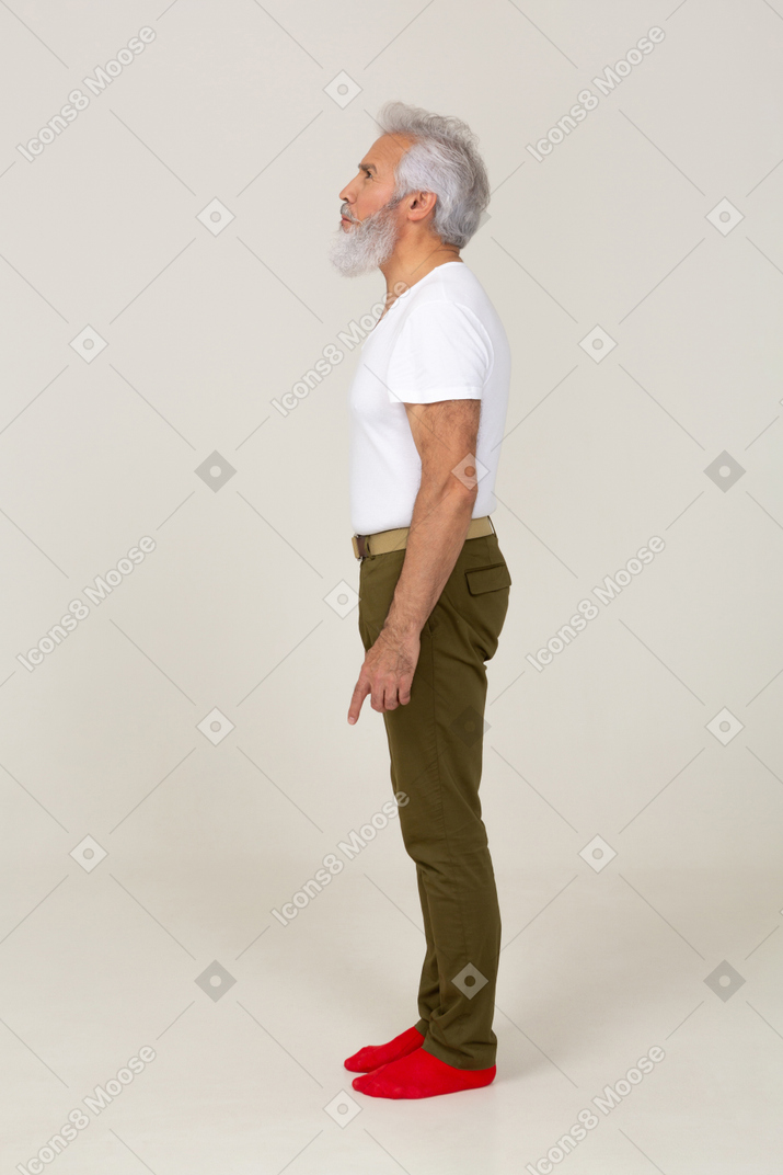 Side view of an annoyed man standing still