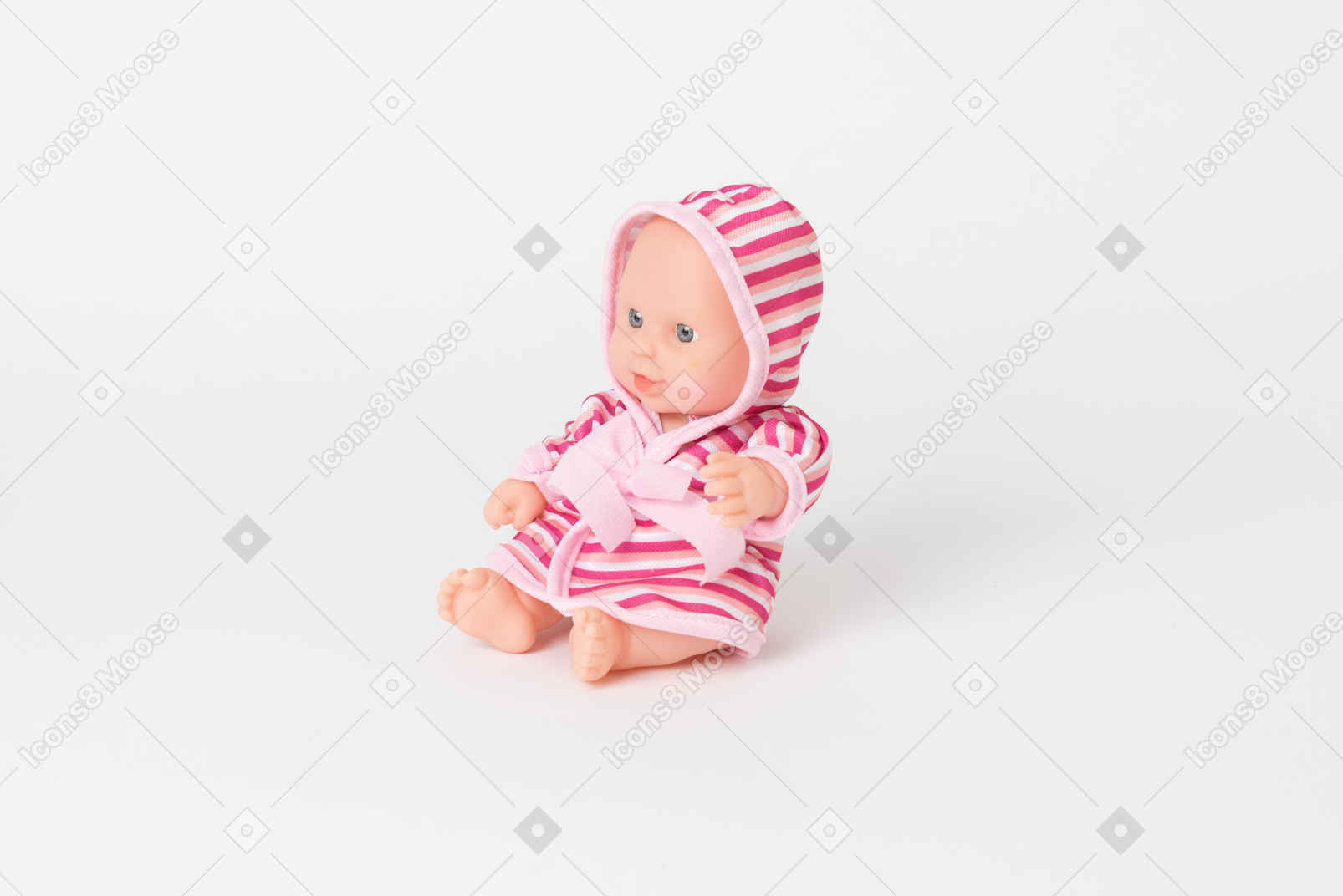 Cute baby doll sitting isolated on a plain white background