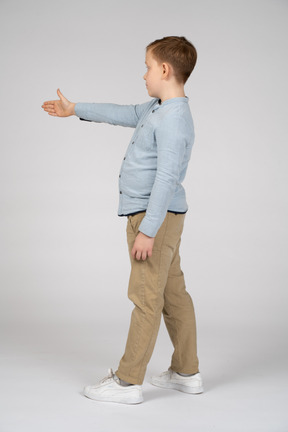 Side view of a boy giving a hand for shake