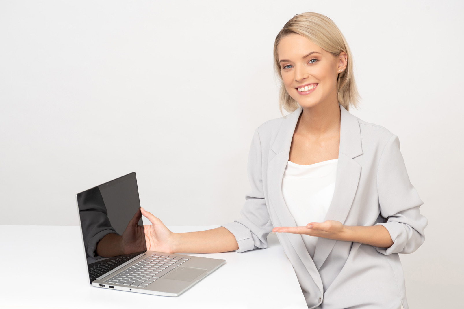 Young businesswoman showing her laptop