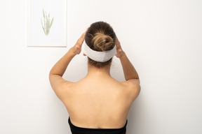 Back view of a woman with bandage over her eyes