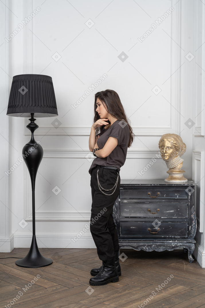 Side view of a thoughtful female rocker putting hand on stomach