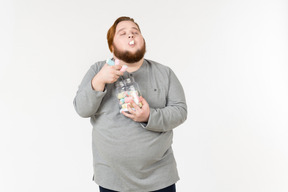 Big bearded guy eating marshmallows with eyes closed