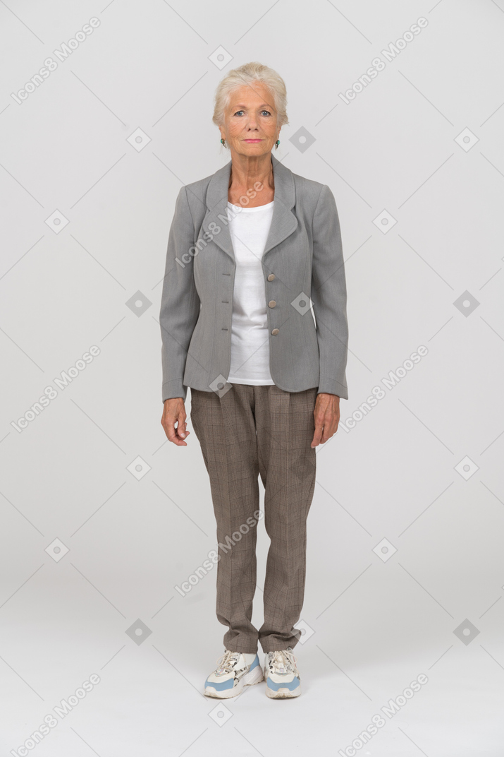 Front view of an old lady in suit looking at camera