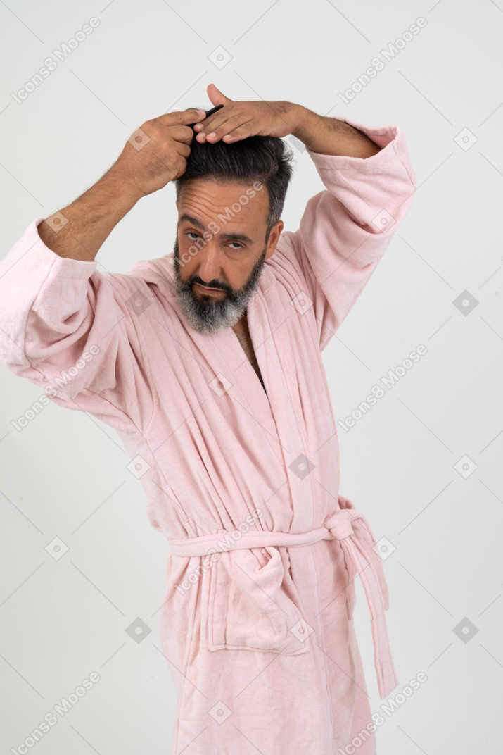 Mature man styling his hair